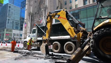 A-street-view-of-men-digging-a-trench-on-Fifth-Avenue-in-NYC-on-a-sunny-day