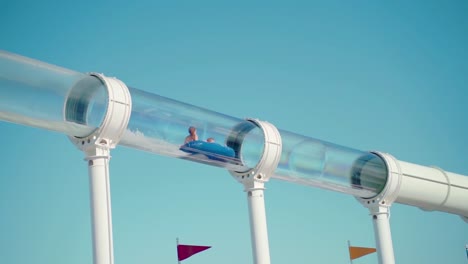 Two-girls-sliding-on-a-water-slide-of-sailing-cruise-ship-on-the-sea