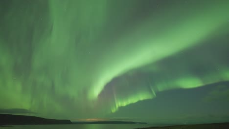 The-awe-inspiring-display-of-vibrant-colors-and-swirling-patterns-of-Aurora-Borealis-above-the-sea
