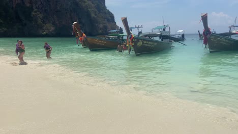 Wide-panning-shot-of-Monkey-beach-in-Phi-Phi-Islands-with-tourists-and-boats