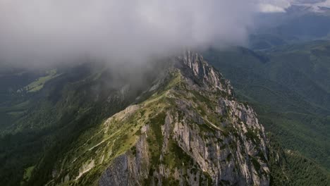 Piatra-craiului-mountains-shrouded-by-flowing-clouds,-aerial-view