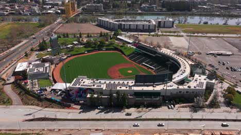 Drone-aerial-flyover-of-Sutter-Health-Park-on-a-sunny-day-in-Sacramento,-California