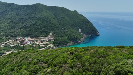 Corfu-island-with-lush-greenery-and-blue-ionic-sea-waters,-aerial-view