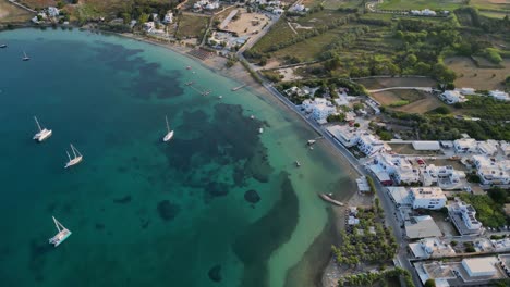 Aerial-footage-of-the-town-and-port-of-Parikia-on-the-island-of-Paros,-one-of-the-many-Cyclades-Islands-in-the-Aegean-Sea