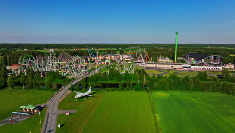 Drone-circling-the-Powerpark-amusement-park,-summer-day-in-Harma,-Finland