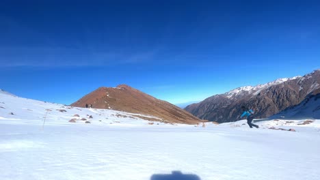 A-man-with-a-backpack-travels-in-the-mountains-in-winter