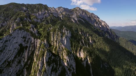 Sunset-light-bathing-Piatra-Craiului's-rugged-peaks,-aerial-view-revealing-nature's-grandeur