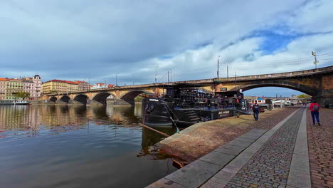 Vintage-Boat-Anchored-On-Vltava-River-Near-Palacky-Bridge-In-Prague,-Czech-Republic