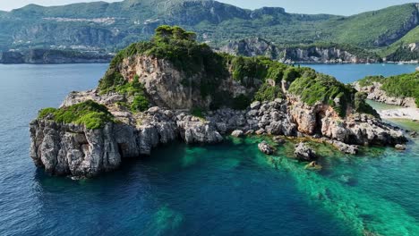 Rocky-cliffs-on-corfu-island,-greece,-with-crystal-clear-ionian-sea-waters,-aerial-view