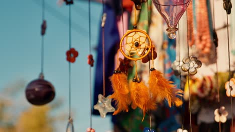 Close-up-on-colorful-dream-catcher-souvenir-spinning-under-the-wind-at-a-hand-craft-store-in-market-street-in-Nubian-Village,-Aswan,-Egypt