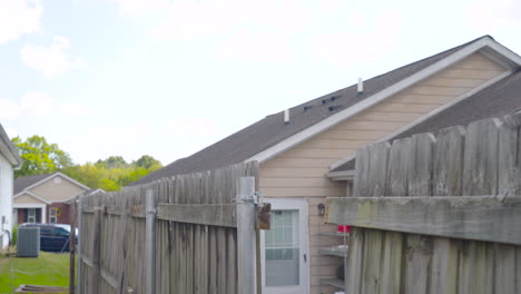 Man-walks-away-from-broken-fence-outside