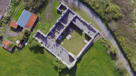 Top-down-rotating-view-of-Annaghdown-Abbey,-Galway,-Ireland