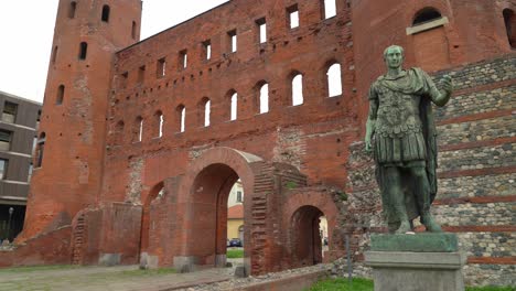 The-Palatine-Gate-together-with-the-ancient-theatre's-remains-with-bronze-Statue-of-Julius-Caesar