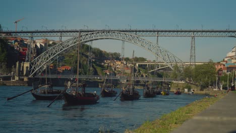 Ponte-Dom-Luis-bridge-in-the-background-with-local-boats-in-the-foreground-swaying-in-the-waves-and-the-wind-on-bright-sunny-day-with-blue-skies