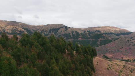 Aerial-over-the-south-east-mountains-of-Cusco,-Kirkas-community,-and-Huanacaure-ruins