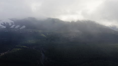 Olympic-Peninsula,-Washington-State,-PNW,-USA---The-Majestic-Olympic-Mountains-Draped-in-Hazy-Fog-Clouds---Drone-Flying-Forward