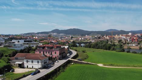 Vista-Vibrante-De-Barcelinhos,-Capturando-Barcelos-Al-Otro-Lado-Del-Río-Con-Encanto-Rural-Y-Paisaje-Urbano---Aéreo