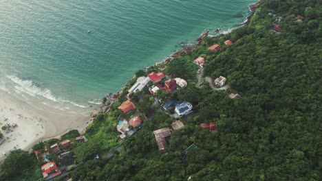 Houses-perched-on-a-rocky-hill-overlooking-Lagoinha-Beach-in-Florianopolis,-Santa-Catarina,-Brazil