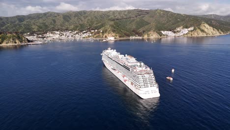 A-large-cruise-ship-near-catalina-island,-california-with-clear-blue-waters-and-scenic-hills,-aerial-view