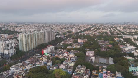 An-expansive-drone-shot-capturing-the-urban-sprawl-of-Chennai,-India,-highlighting-the-mix-of-residential-houses-and-commercial-structures