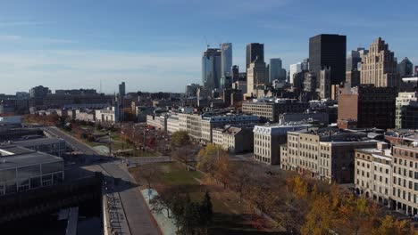 Aerial-view-of-Old-Port-of-Montreal-during-a-sunny-day-with-modern-cityscape-at-distance