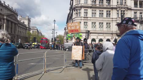 A-climate-change-protester-with-their-signs-at-Westminster