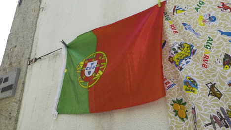 Portugal-national-flag-hung-up-on-clothesline-by-clothespins-waving-in-wind