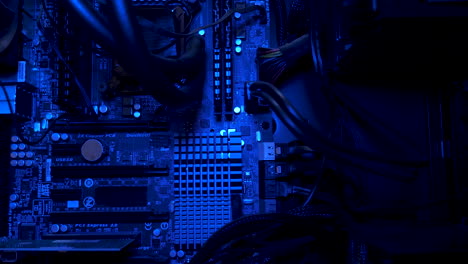 Detailed-shot-of-technological-electronic-board-with-LED-lights-and-cables,-macro-closeup