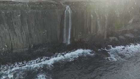 Static-shot-of-the-beautiful-Mealt-Falls-on-the-Isle-of-Skye-with-waves-crashing