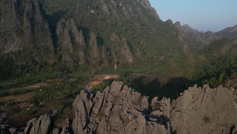 drone-shot-of-jagged-cliffs-in-Vang-Vieng,-the-adventure-capital-of-Laos