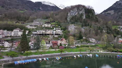 A-helicopter-performing-maneuvers-in-the-charming-town-of-Weesen,-located-on-the-shores-of-Lake-Walensee-in-the-canton-of-St