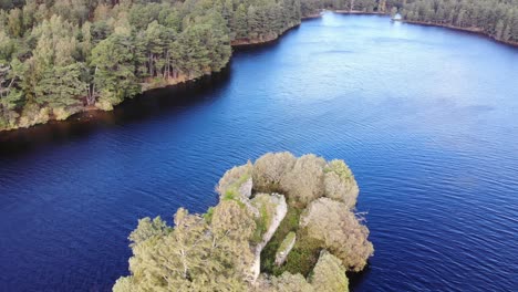 Aerial-View-Of-Loch-an-Eilein-Surrounded-By-Pines-Of-Rothiemurchus-Forest