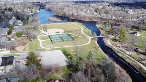 Aerial-Flyover-Of-Cedar-Creek-Flowing-Through-The-Beautiful-And-Charming-Downtown-Neighborhood-Of-Cedarburg,-Southeastern-Wisconsin