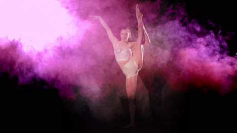 Acrobat-shows-good-balance-and-does-leg-hold-pose-with-pink-and-purple-smoke