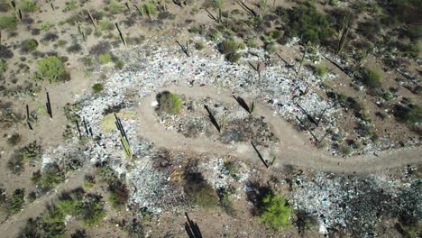 Garbage-Scattered-Along-the-Roadside-in-the-Desert-Outskirts-of-Mulege,-Baja-California-Sur,-Mexico---Aerial-Topdown-Shot