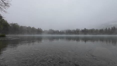 Steady-shot-of-Rain-and-Snow-falling-on-Mystical-Lake