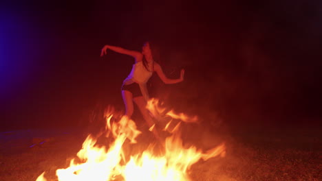 asiatic-female-young-model-girl-dancing-near-the-fire-bonfire-flame-at-night