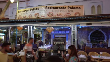 Vibrant-and-illuminated-restaurant-providing-traditional-Arabic-cuisine-and-Moroccan-gastronomy-experiences-in-the-centre-of-Chefchaouen-at-night