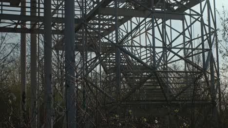 Eerie-abandoned-industrial-frame-in-Zagreb,-Croatia,-engulfed-by-nature's-reclaim