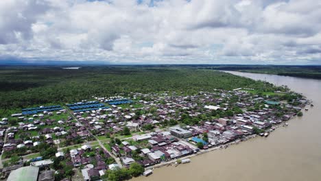 Drone-shot-of-Atrato-river-and-residential-areas-on-its-banks-in-Choco,-Colombia