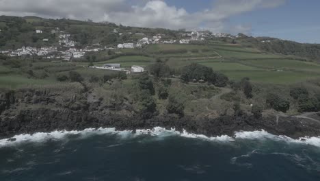 Flying-toward-village-and-coastline-of-Santo-Antonio-of-Azores-islands