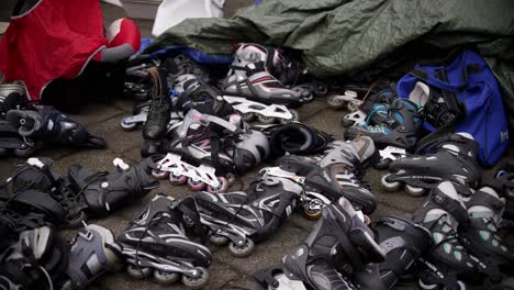 Second-hand-scates-and-roller-blades-spread-out-at-garage-sale-at-flea-market