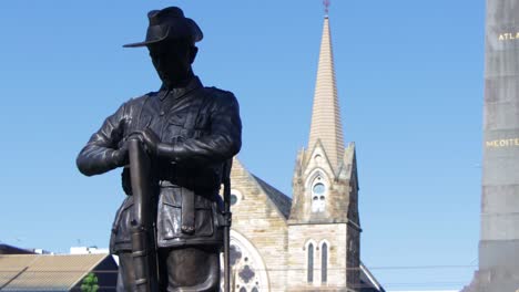 bronze-Statue-of-soldier-at-day-with-cathedral-in-background