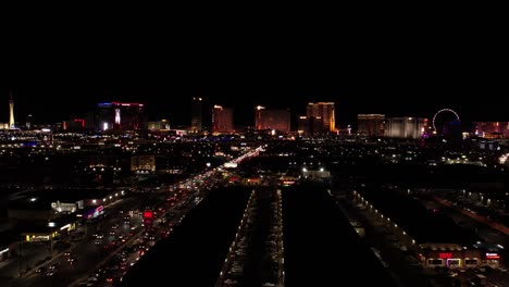 Las-Vegas-NV-USA,-Aerial-View-of-Night-Traffic-With-Downtown-and-Strip-Casino-Hotel-Buildings-in-Background