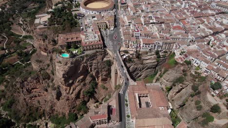 aerial-high-angle-panning-footage-of-El-Tajo-Gorge-Bridge-and-bullring-in-Ronda,-Andalusia-spain