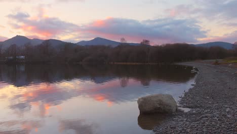 Colorful-Sky-Reflecting-In-The-Waters-Derwentwater-At-Sunset-In-Keswick,-Lake-District,-Cumbria,-England