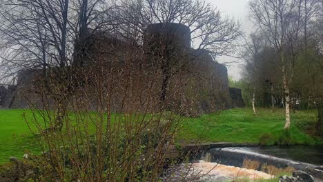 Calm-shot-of-Athenry-Castle-with-little-cascade-in-the-foreground