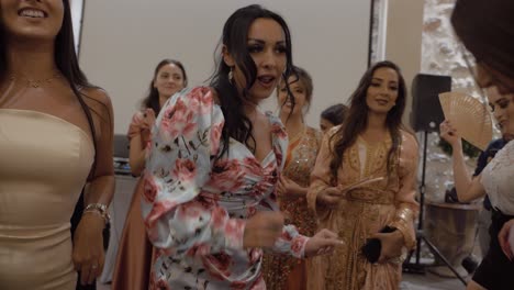 Slow-motion-shot-of-beautiful-women-dancing-at-a-wedding-enjoying-themselves