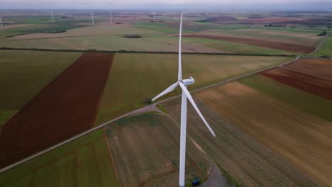 POI-wind-turbine-in-the-middle-of-cultivated-fields-in-France,-stormy-weather