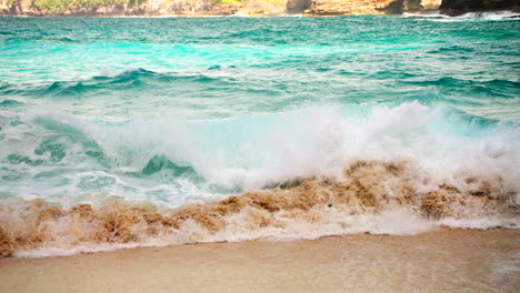 Slow-Motion-Of-Sea-Waves-Crashing-On-Golden-Sand-Shore-In-Bali,-Indonesia